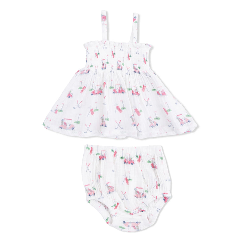 A baby girl's two-piece outfit set consisting of a white smocked dress with thin shoulder straps and matching white smocked bloomers, both decorated with a colorful pink, green, and blue golf-themed print, shown against a plain white background.