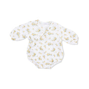 White baby onesie with yellow floral pattern on a white background