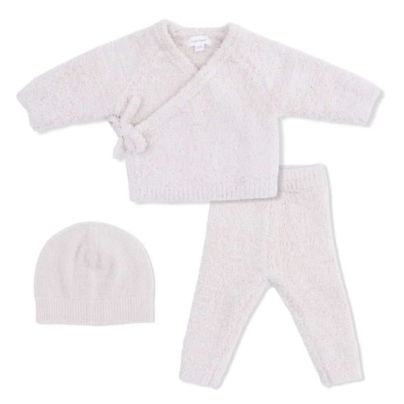 Baby outfit set with cardigan, pants, and hat on a white background