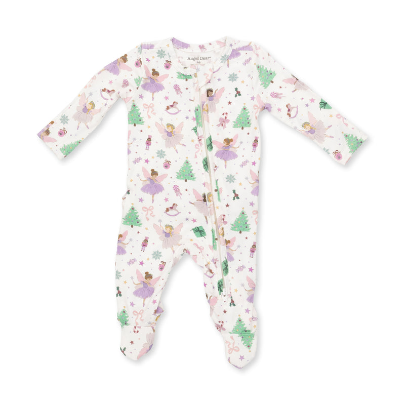 A baby footed sleeper with long sleeves and a front zipper, featuring a whimsical print of ballerinas, Christmas trees, and snowflakes on a white background.
