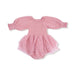 A long sleeve baby bubble outfit in a soft rose pink color. The bodice features stretchy smocking, the sleeves are made of lightweight muslin with elastic cuffs, and the bottom is attached to a layered pink tulle tutu skirt. The romper includes built in bloomers with snaps at the bottom.