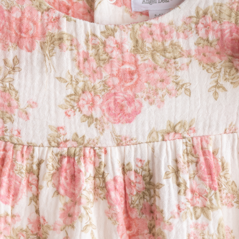 Floral patterned fabric with pink flowers on a white background