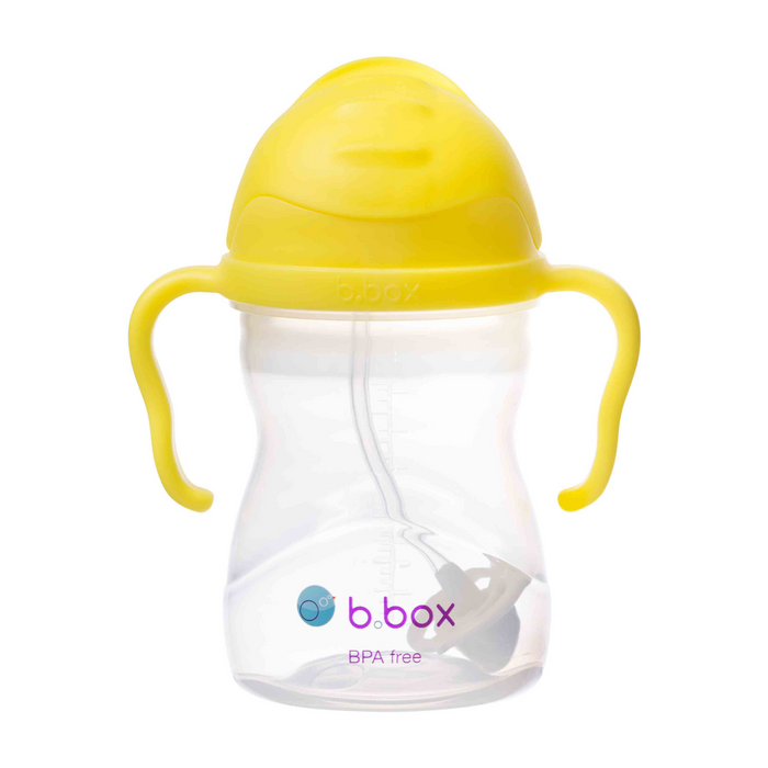 Clear sippy cup with yellow lid and handles on a white background, featuring the b.box logo.