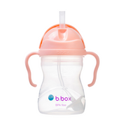 Pink sippy cup with straw and handles on a white background, featuring the b.box logo.