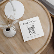 Round wooden table with a zebra-themed book on a white surface
