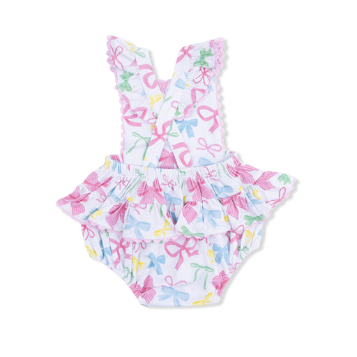 Children's sunsuit with colorful bow pattern on a white background