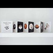 Row of books with sports-themed illustrations on a white shelf