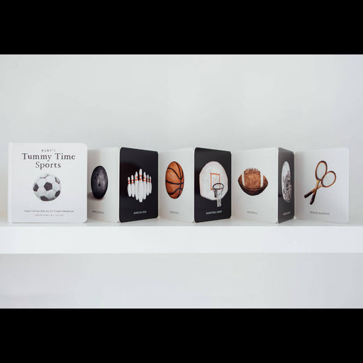 Row of books with sports-themed illustrations on a white shelf