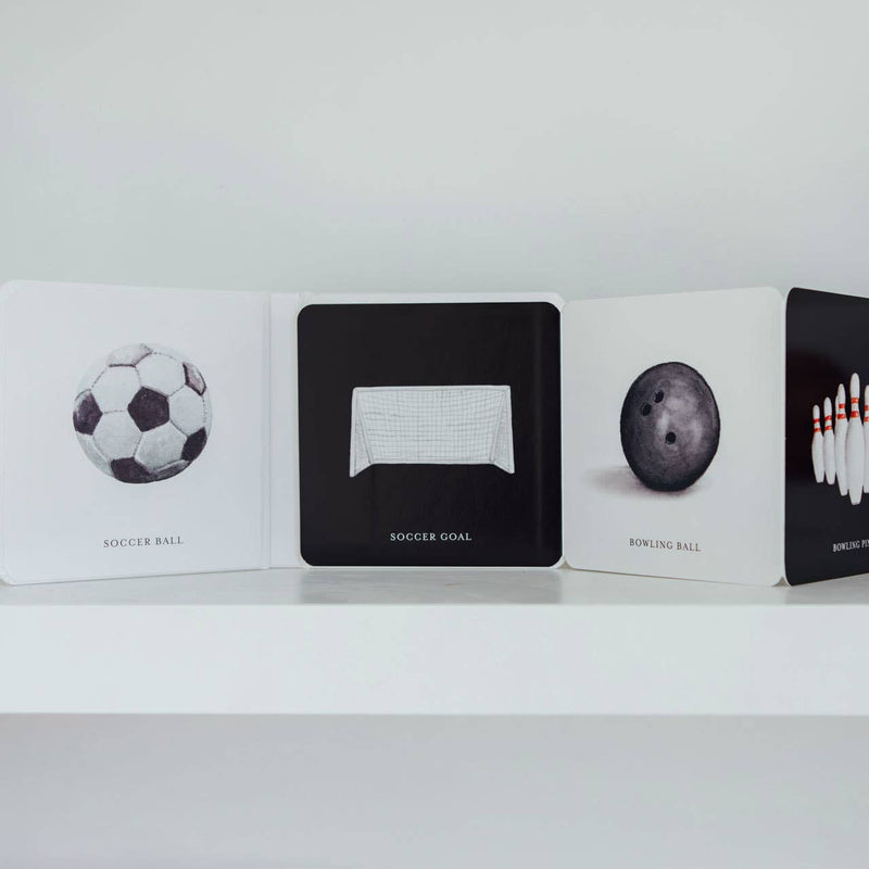 Collection of card decks with sports-themed designs on a white shelf.