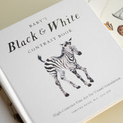 Book titled 'Baby's Black & White Contrast Book' with a zebra illustration on a light background.