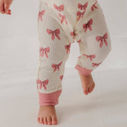 Close-up of the pink ribbed ankle cuffs on the babysprouts Rose Elegance Bows waffle romper