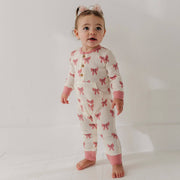 Toddler standing in the babysprouts Rose Elegance Bows waffle romper