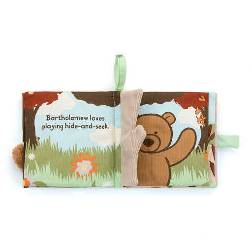 Children's soft book with bear illustration and text on a white background