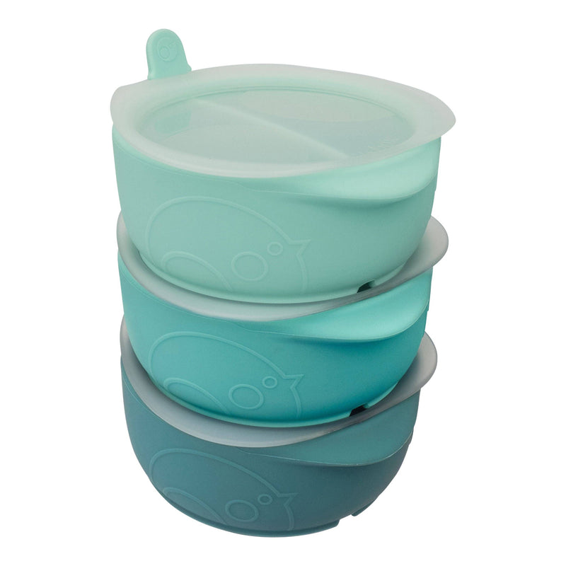 Stack of teal silicone bowls with fish designs on a white background