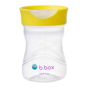 Clear snack cup with yellow lid on a white background, featuring the b.box logo.
