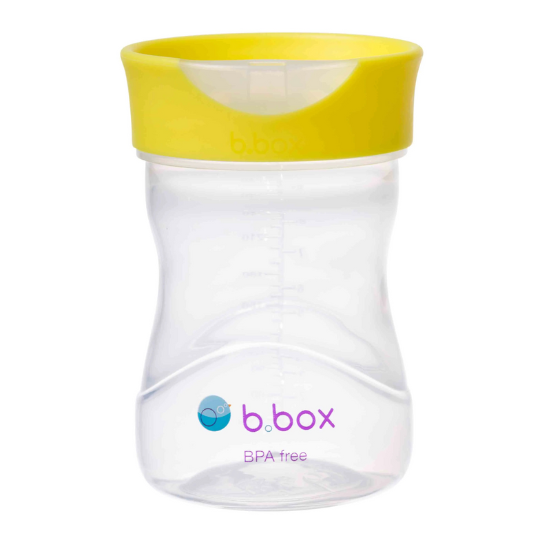 Clear snack cup with yellow lid on a white background, featuring the b.box logo.