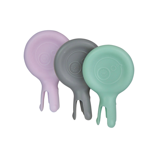 Three silicone baby stabbing forks  in purple, gray, and green on a white background