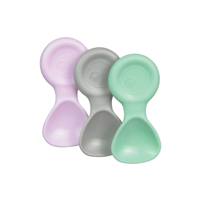 Three pastel-colored silicone baby spoons on a white background