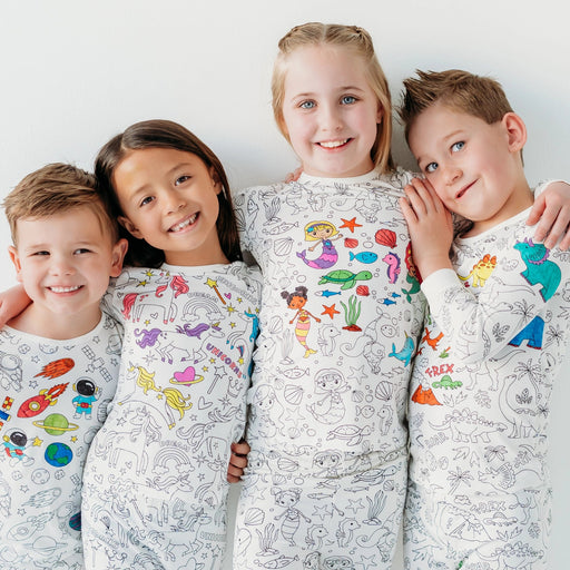 Group of children wearing finished mermaid colorable pajamas with colorful designs