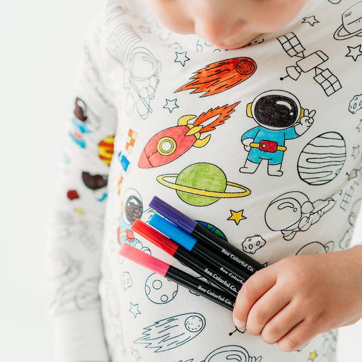 Close-up of space colorable pajama top being colored with fabric markers