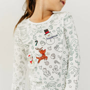 Close-up of child wearing Christmas colorable pajamas with partially colored designs