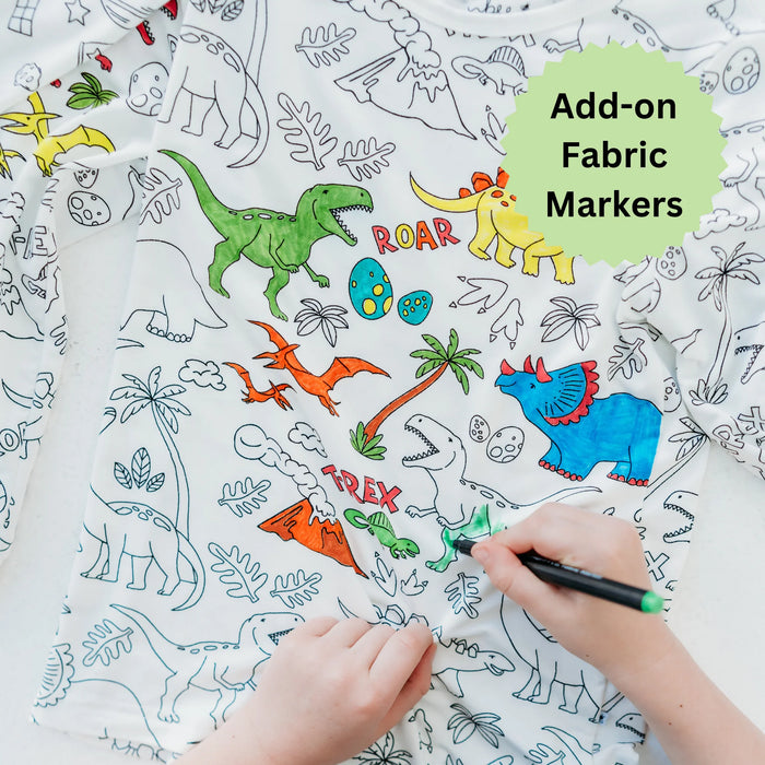 Close-up of child coloring dinosaur print on pajama top with fabric markers