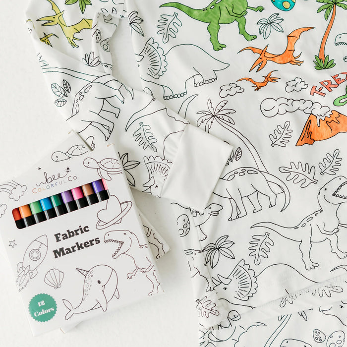 Fabric markers shown on top of dinosaur colorable pajamas