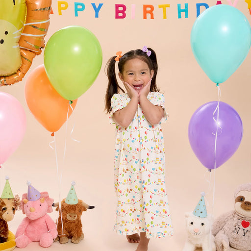 Toddler wearing Birthday Babe nightgown with balloons