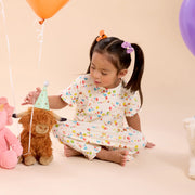 Child playing in Birthday Babe RightFit magnetic nightgown