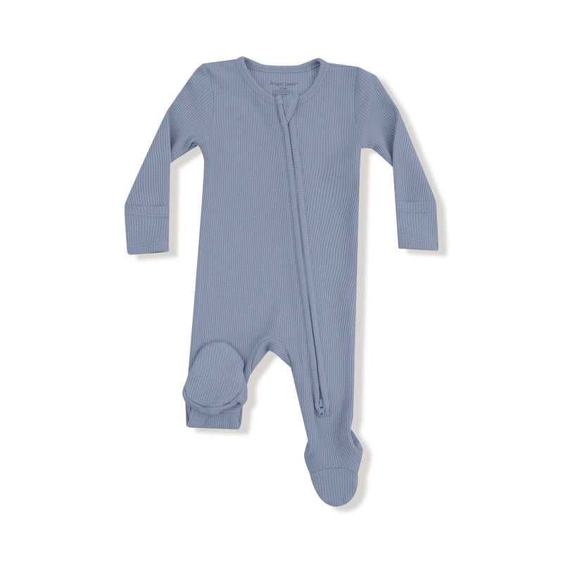 Light blue waffle-knit baby footie with long sleeves and diagonal zipper laid flat on a white background.