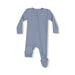 Light blue waffle-knit baby footie with long sleeves and diagonal zipper laid flat on a white background.