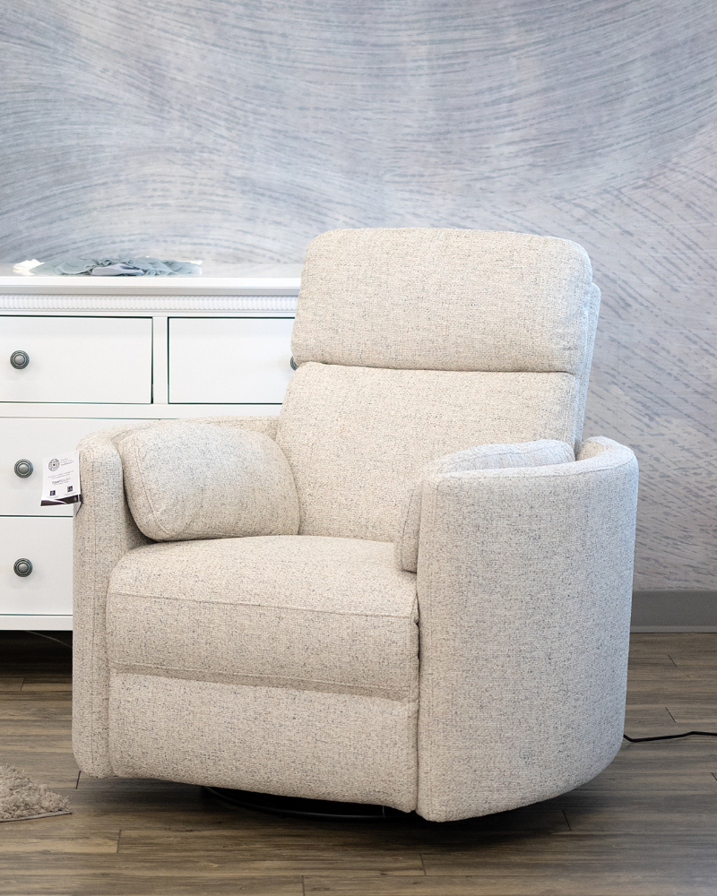 Beige recliner chair in a room with a textured wall and white dresser.