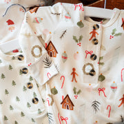 Baby clothes with Christmas-themed patterns on a white background
