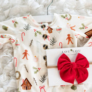 Children's Christmas-themed shirt with a red hair bow and LouLou brand card on a white textured background