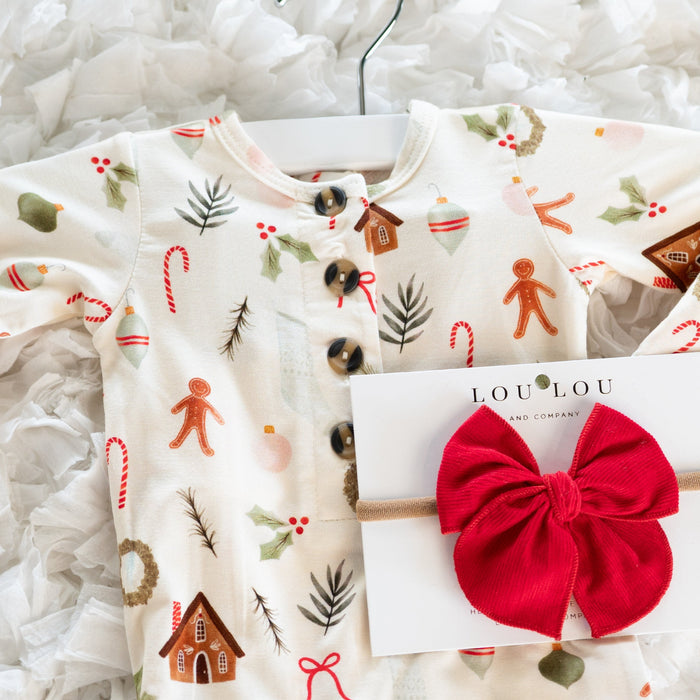 Children's Christmas-themed shirt with a red hair bow and LouLou brand card on a white textured background