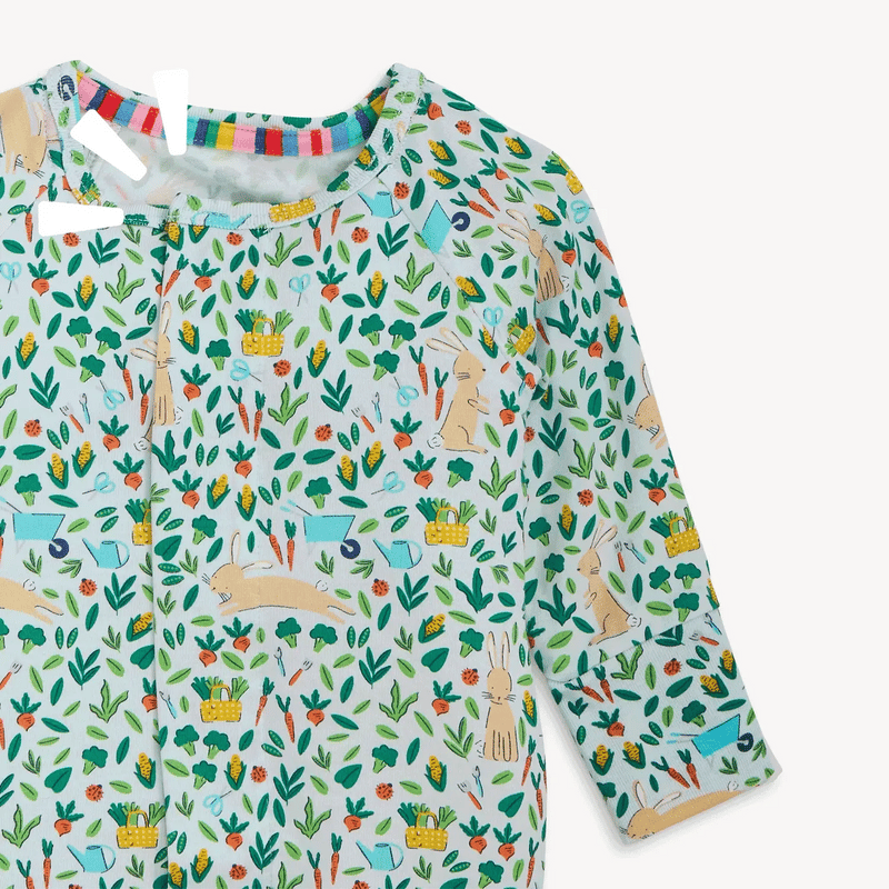 Close-up of Bunny Garden magnetic footie with botanical print and fold-over cuffs