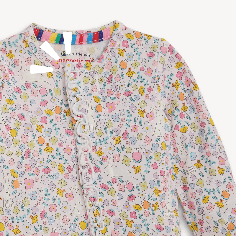 Close-up of Bunny Blossom coverall showing ruffle trim and magnetic front closure