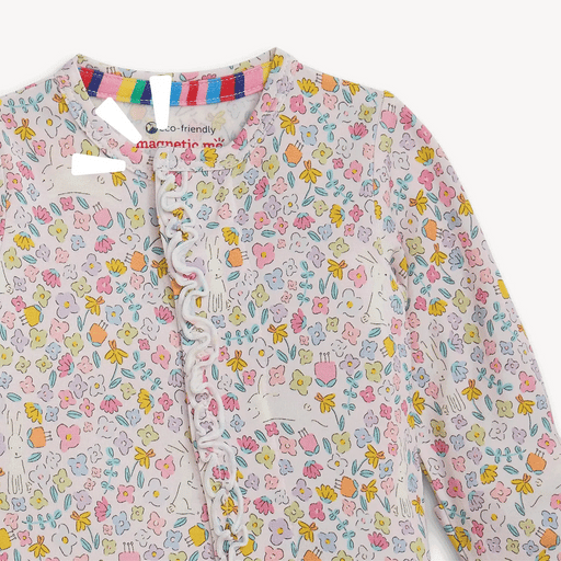 Close-up of Bunny Blossom coverall showing ruffle trim and magnetic front closure