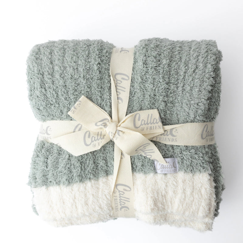 Sage Alani blanket set stacked and wrapped with a branded ribbon