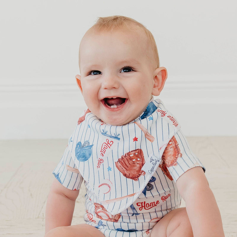 Smiling baby wearing the baseball pinstripe Copper Pearl All Star bandana bib