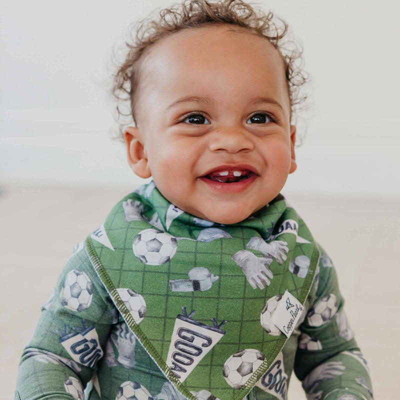 Smiling baby wearing the green soccer Copper Pearl All Star bandana bib