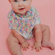 Close-up of a baby wearing the wildflower Copper Pearl Catherine bandana bib