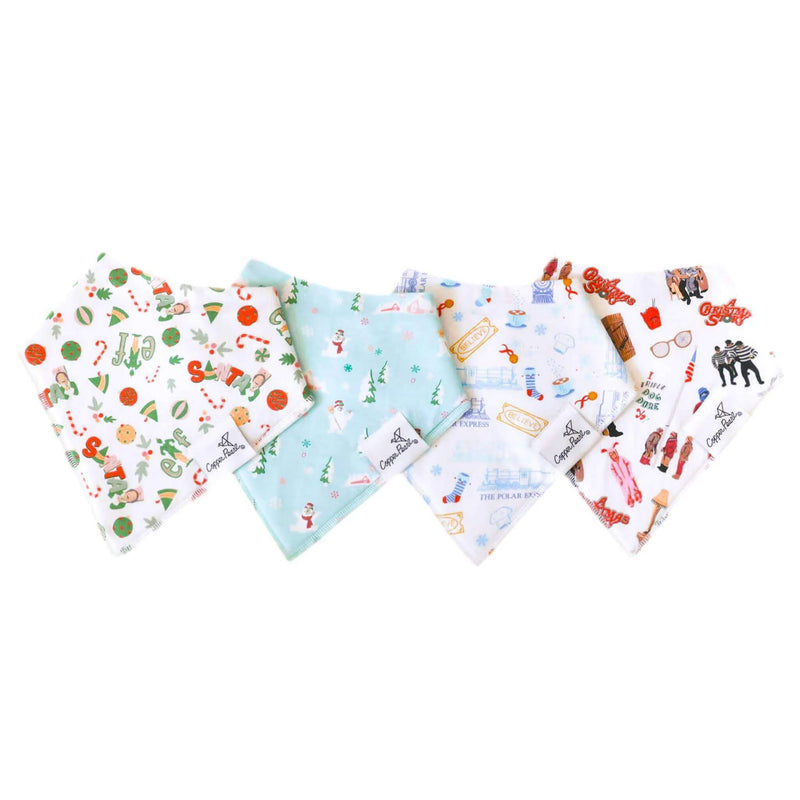 Four Copper Pearl Christmas Classics bandana bibs flat lay in coordinating holiday prints on white background