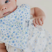 Close-up of the blue floral Copper Pearl Genevieve bandana bib on a baby