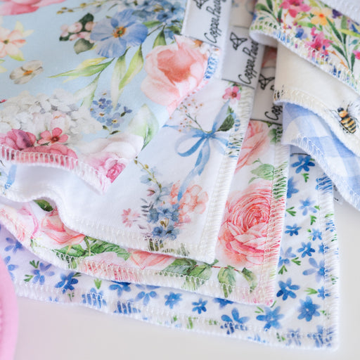 Copper Pearl Genevieve bandana bibs stacked in pink rose and blue floral prints