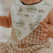 Close-up of a Copper Pearl Hundred Acre Wood bandana bib with a Pooh scenery print