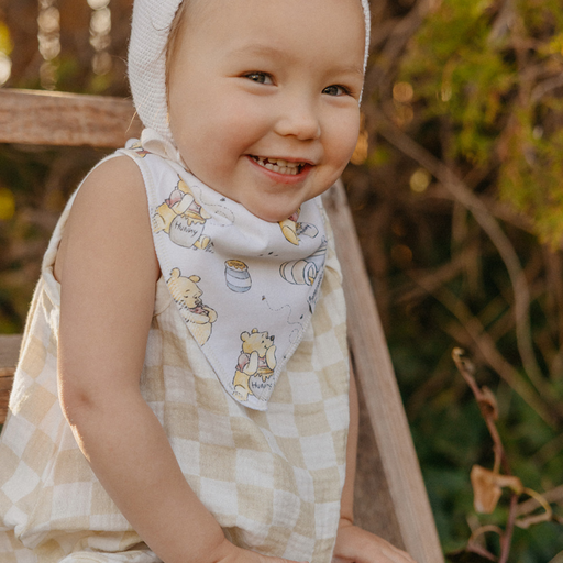 Baby wearing a Copper Pearl Hundred Acre Wood Winnie the Pooh bandana bib