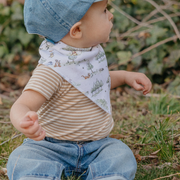 Toddler wearing a Copper Pearl Hundred Acre Wood Winnie the Pooh bandana bib outdoors