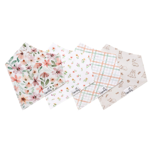 Four Natalie bandana bibs laid flat in floral, ditsy floral, plaid, and woodland critter prints