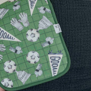 Close-up of the green soccer print and stitched edge on a Copper Pearl All Star burp cloth